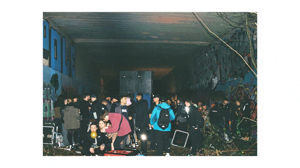 Photo of people raving at a free party in an abandoned warehouse